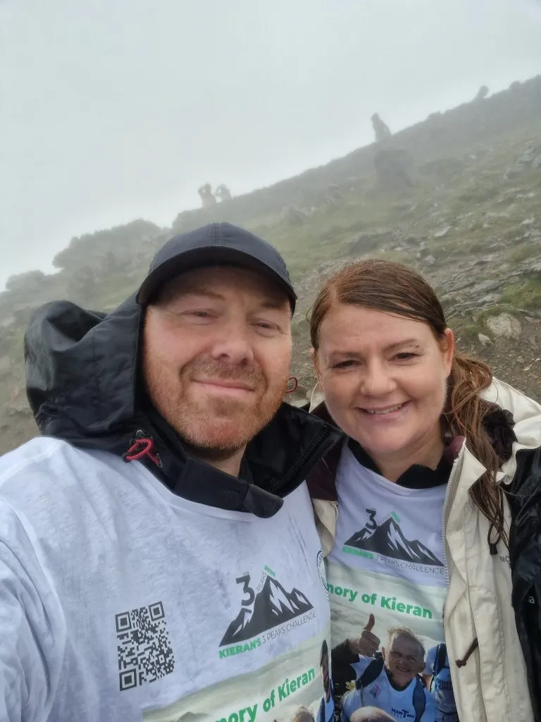 Two participants wearing Kieran memorial Three Peaks Challenge shirts