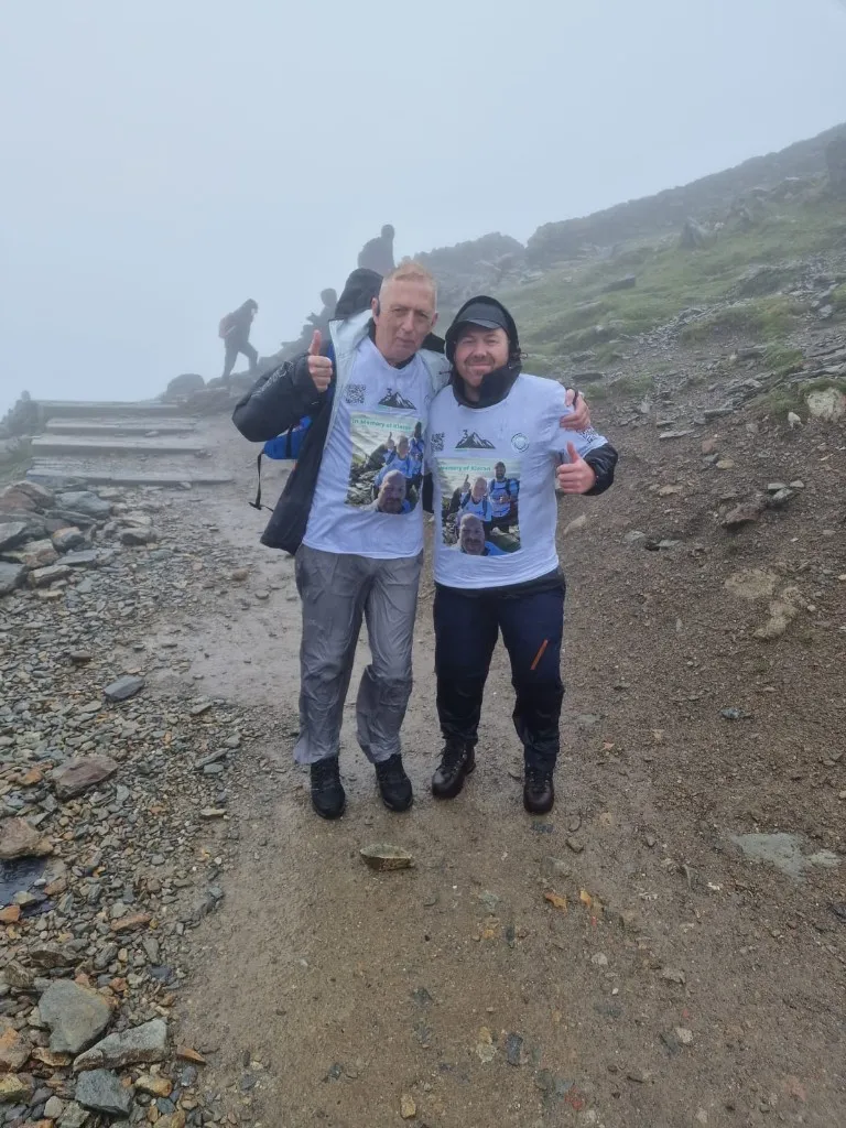 Two challenge participants wearing Kieran memorial shirts on the mountain